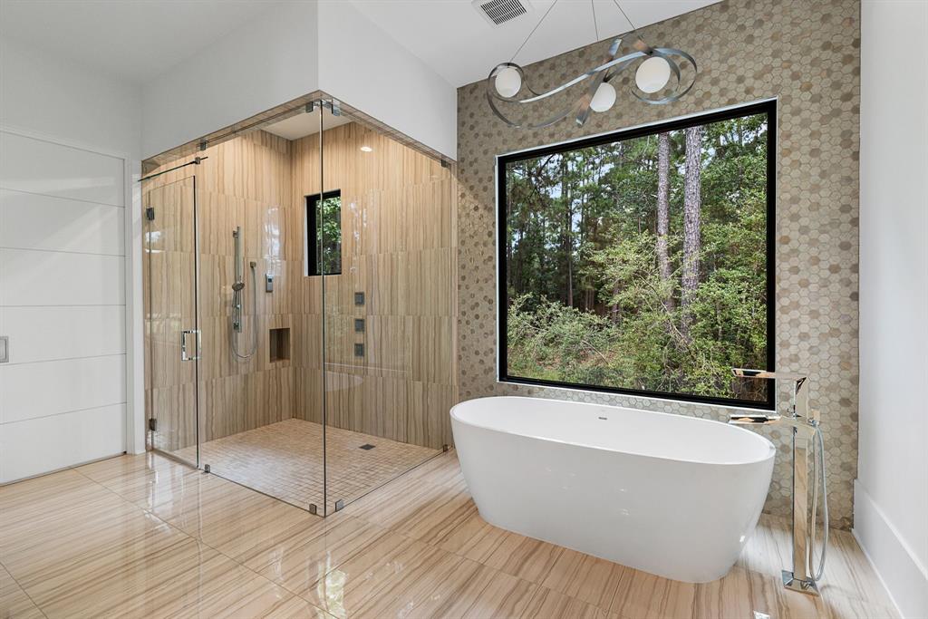 An incredible green backdrop is ideal for unwinding in a Maribel soaker tub or steam shower.