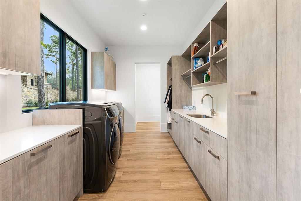 Plenty of natural light in this well-designed and organized laundry room that is sure to lighten your load.
