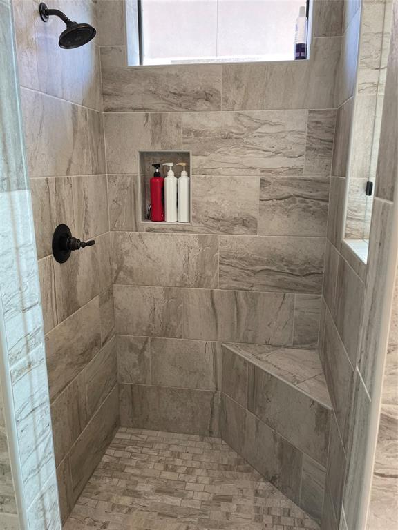 Master shower with bench and niche areas