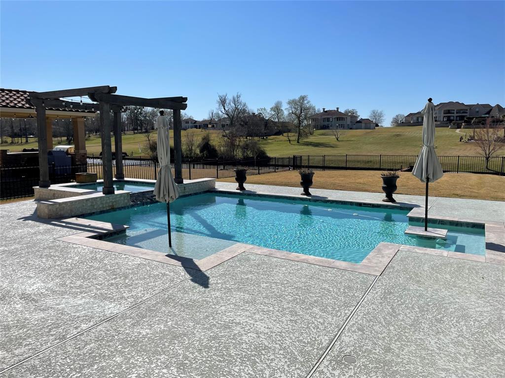 Pool area with hot tub and sitting area and sun ledge