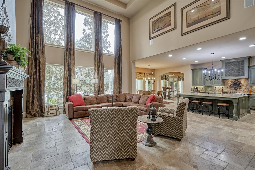 Two story windows with custom drapes and open to the Kitchen and Breakfast are.
