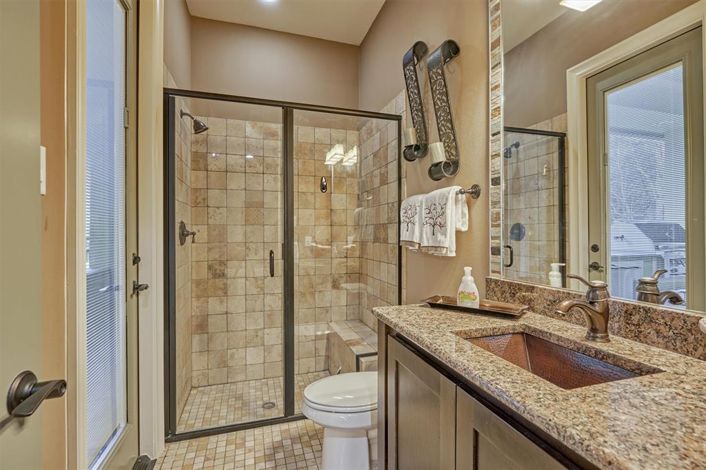 The full Bath with a separate entrance to the covered Patio includes a large walk-in shower.