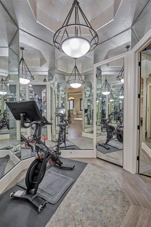 The Dressing/Exercise area is surrounded by mirrors and leads into the large walk-in closet.