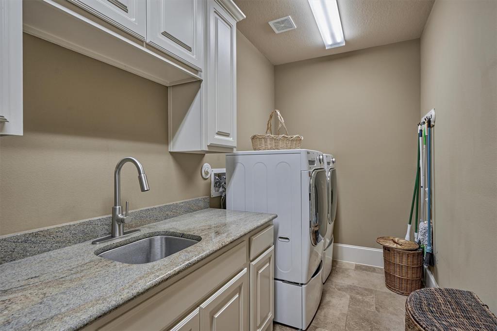 Large Utility Room is located off of the service hall and includes built-ins, prep area and sink.