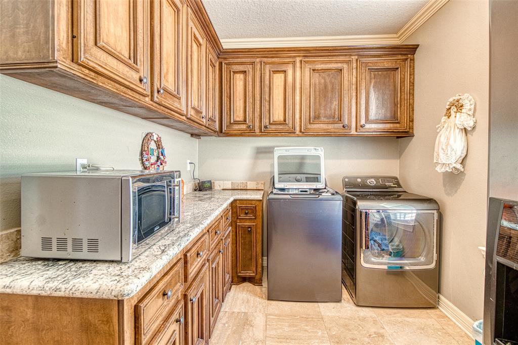 [Laundry Room] More custom cabinetry available in this spacious laundry room.