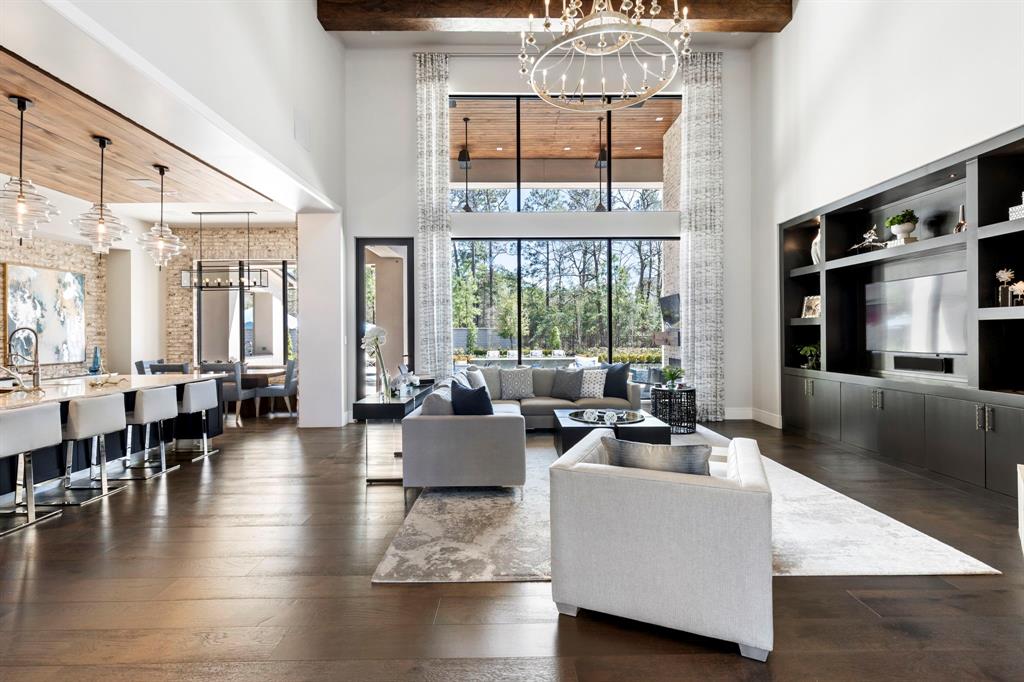 An open concept floor plan blends natural tones and textiles creating dramatic and sophisticated spaces.