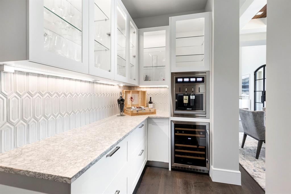 Butler Pantry: Baroque tile backsplash, quartz counters, wine dispenser, mini fridge and abundant storage.