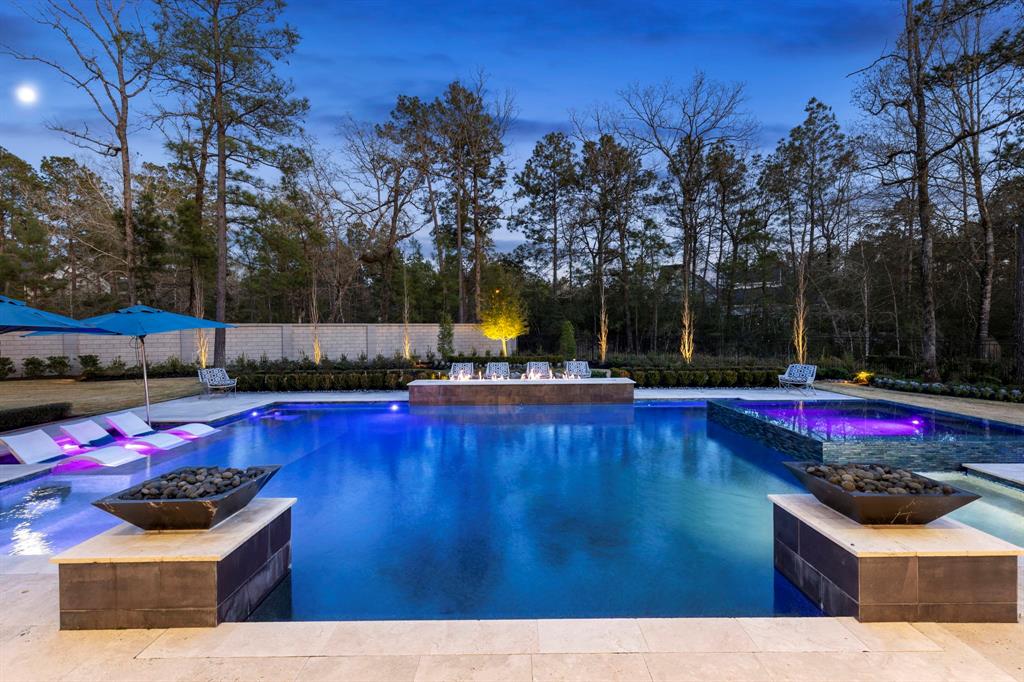 No shortage of wow-factor! In a private setting, this stunning Regal Pool features an oversized spa, tanning shelf, fire bowls and firepit, providing the ultimate in quiet relaxation.