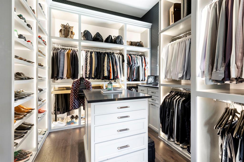 A gentleman's closet that boasts plenty of organized storage for everything from work, play clothing to everything in between.