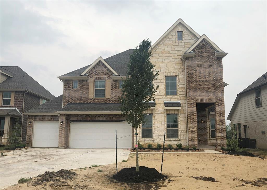 Stunning Andrew home design by K. Hovnanian® Homes with elevation A in beautiful Waterstone on Lake Conroe. (*Artist rendering for illustrative purposes only, three car garage not shown).