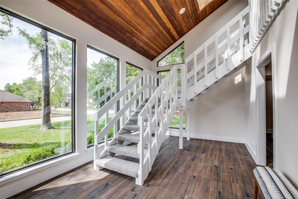 Stairs lead up to family, kitchen, and primary retreat.