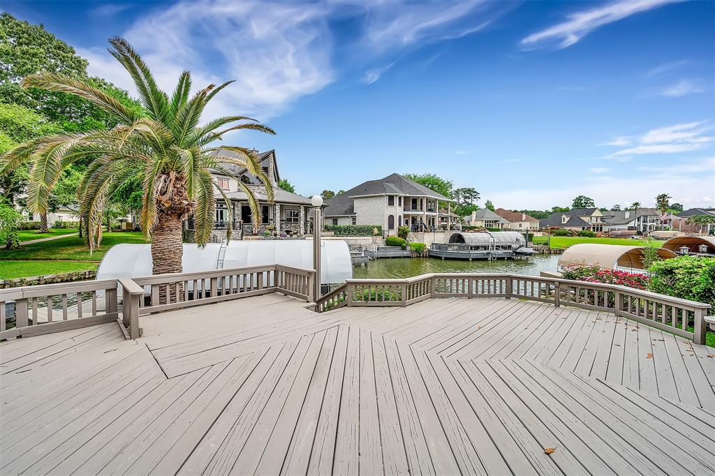 Stunning lake views from the expansive deck w/ covered boat slip, fishing dock, & grass area.