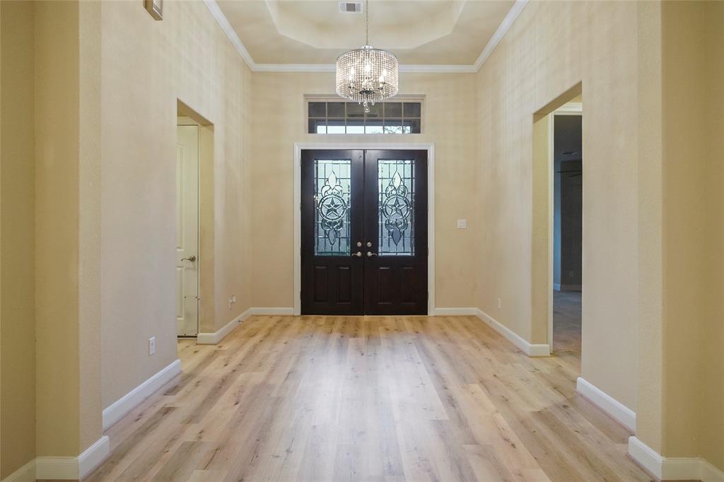Inviting  entry with double doors, lighting and trey ceiling