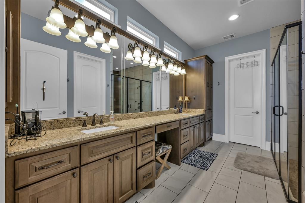 Master bath with his and hers sinks and a oversized walk in closet