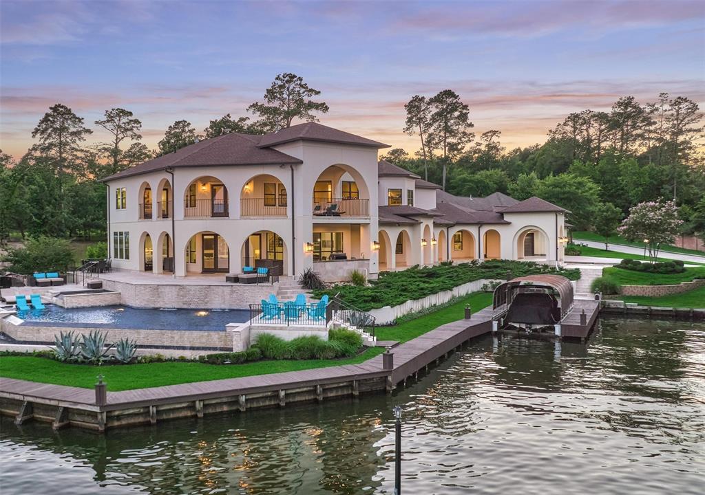 Beautiful custom luxury waterfront house with an abundance of lake views and natural light from glass-paneled exterior doors & a plentitude of windows. Before construction, the owners rebuilt the bulkhead & dredged water access. DEEP WATER - Water depth under boat slip measures approximately 7’ at normal lake levels.