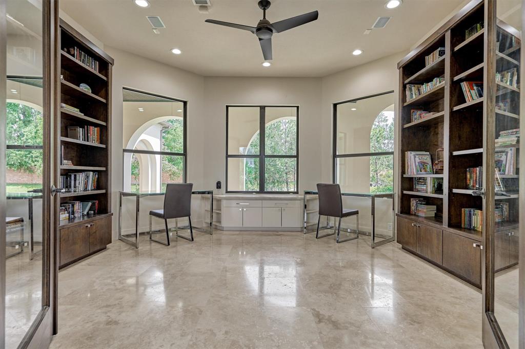 Study/Library w/ solid wood site-built custom bookshelves and cabinets, French glass doors & views of the lake!