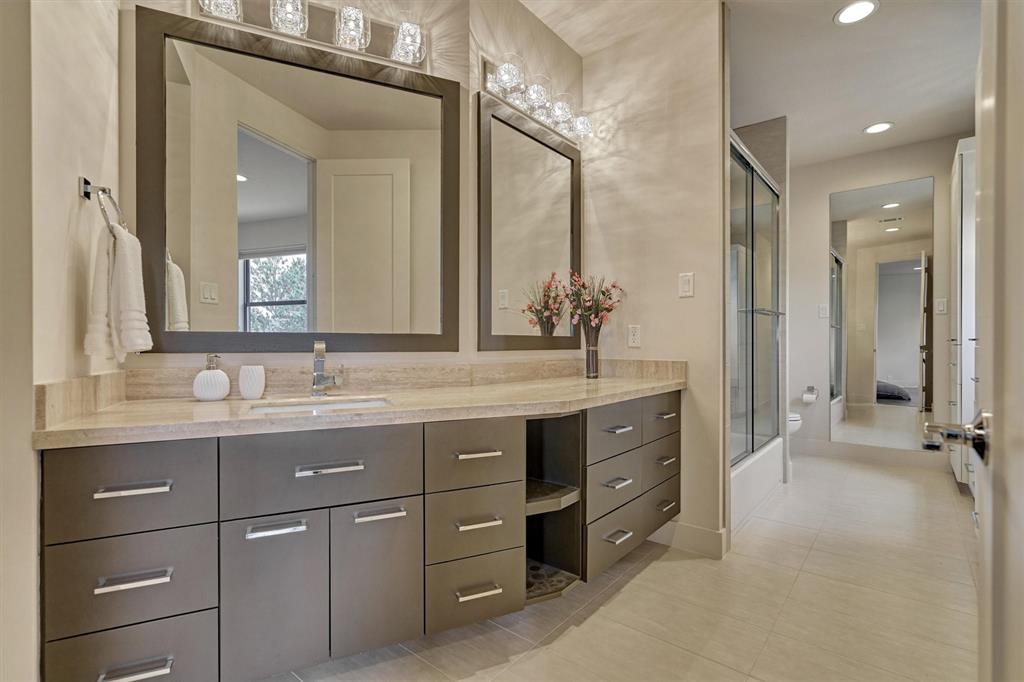 Note that every bathroom has custom floating cabinets & travertine countertops.