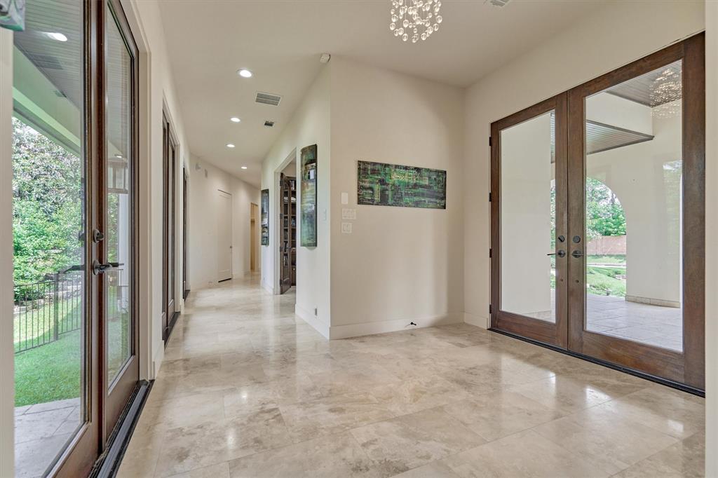 FOYER - Stained Mahagony doors greet your guests upon arrival and lead to the receiving hall w/ additional access to the fenced courtyard, main living area to the left & secondary rooms to the right.
