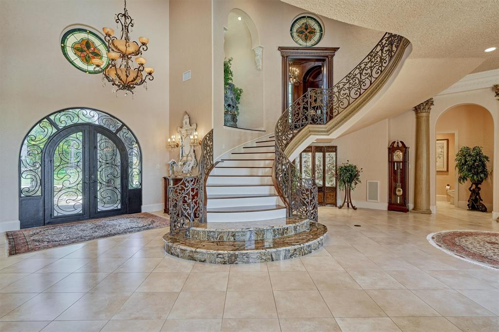 Gorgeous view from the front door entry way with the grand staircase leading up to the office/study and second story.