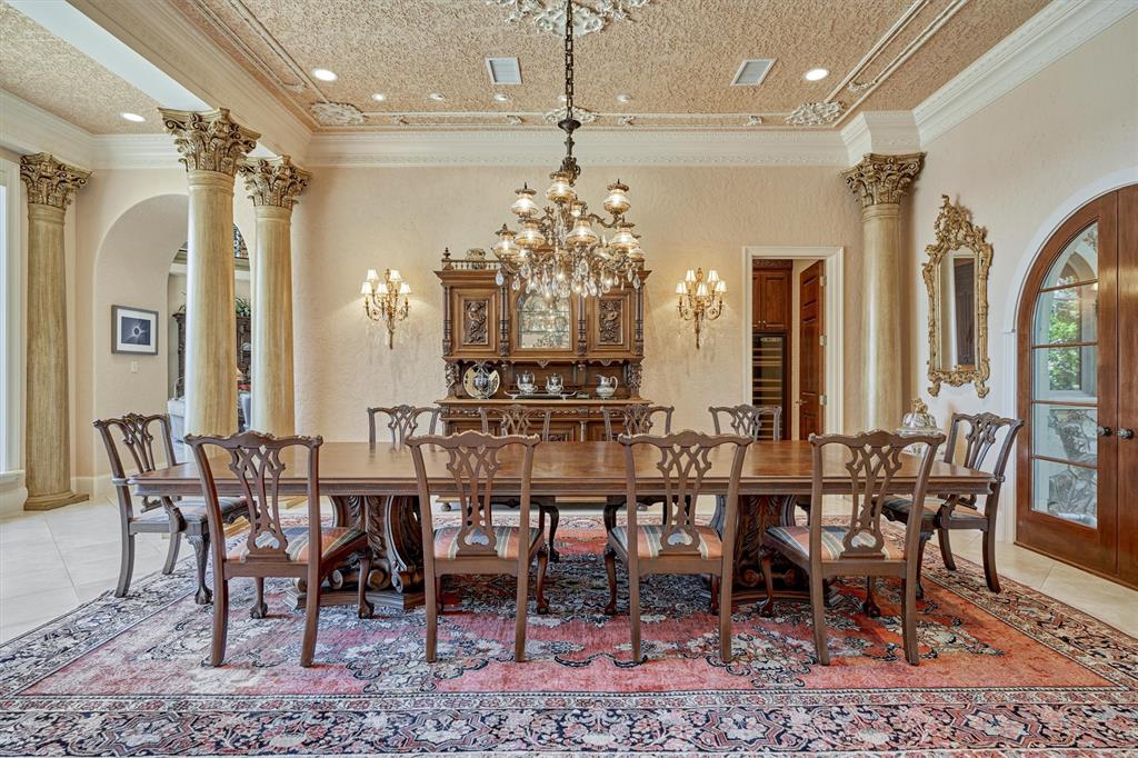 Another view of the formal dining room. The home was designed to transition from room to room. The open floor plan and the abundance of architecturally balanced windows to match the interior arches allow for beautiful lake and wooded views and is perfect for entertaining.