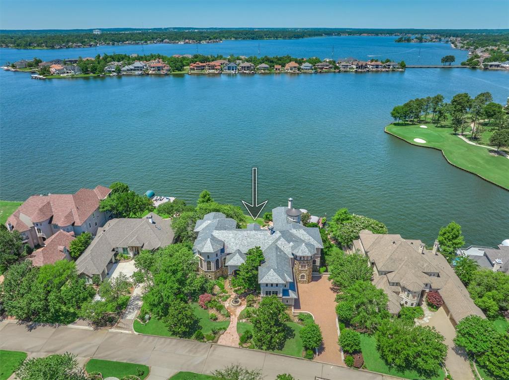 Beautiful view from above overlooking this gorgeous home with open water and the signature par 3 number 14 Weiskopf of Bentwater