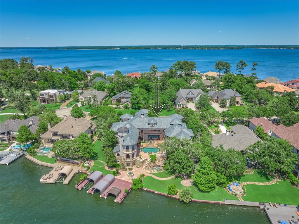 Eagle eye's view from the back of the home.  Notice the 3 boat slips and the large decking area to relax and how much of lake frontage this home has.  Imagine watching the sunset from the boat docks while having a glass of wine in the evenings.