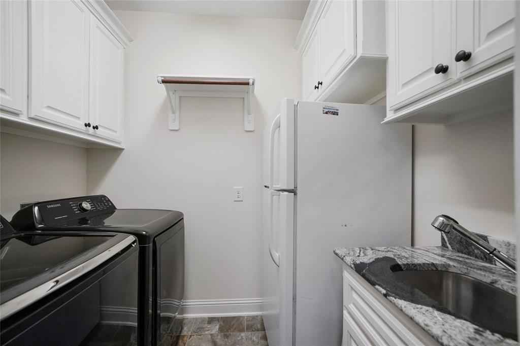 Utility room located on the first floor with room for a fridge.