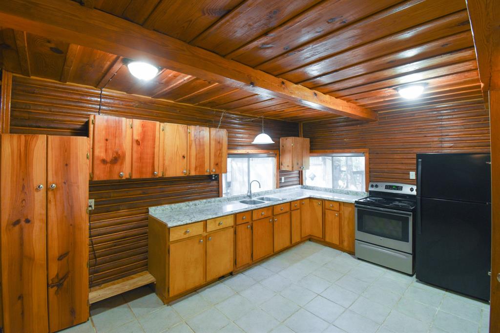 Such charm! Beautiful wood ceiling, walls and cabinetry in the kitchen.