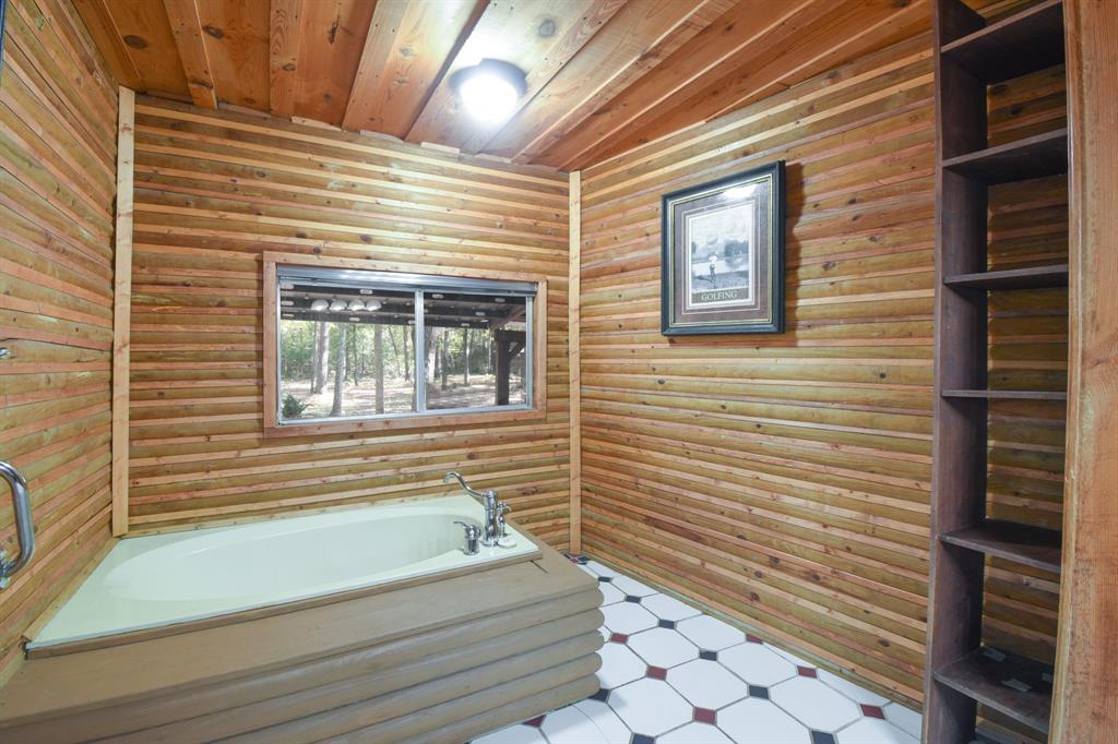Spacious primary bathroom. Love those log cabin walls!